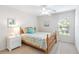 Bright bedroom with a wooden bed frame, white walls, and carpet flooring at 4845 Post Pointe Dr, Sarasota, FL 34233