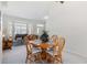 Cozy dining area with a wood table and chairs, adjacent to a bright living room at 4845 Post Pointe Dr, Sarasota, FL 34233