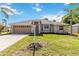 Charming single-story home with a well-maintained lawn, beautiful landscaping, and a two-car garage at 4845 Post Pointe Dr, Sarasota, FL 34233