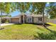 Well-manicured lawn complements this tan single story home and two car garage at 4845 Post Pointe Dr, Sarasota, FL 34233