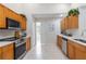 Modern kitchen featuring stainless steel appliances, light wood cabinets, and tile flooring at 4845 Post Pointe Dr, Sarasota, FL 34233