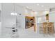 Bright, open kitchen with stainless steel appliances and a breakfast bar, adjacent to the dining area at 4845 Post Pointe Dr, Sarasota, FL 34233