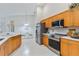 Bright kitchen features stainless steel appliances, quartz countertops, and light wood cabinets at 4845 Post Pointe Dr, Sarasota, FL 34233