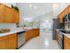 Modern kitchen featuring stainless steel appliances, quartz countertops, and light wood cabinets at 4845 Post Pointe Dr, Sarasota, FL 34233
