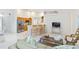 Open-concept living space flows into kitchen with bar seating and stainless steel appliances at 4845 Post Pointe Dr, Sarasota, FL 34233