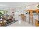 Open-concept living room featuring tile floors, modern decor, and access to the kitchen and dining areas at 4845 Post Pointe Dr, Sarasota, FL 34233