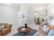Open floor plan showcasing the living room and dining area, filled with natural light at 4845 Post Pointe Dr, Sarasota, FL 34233