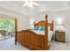 Spacious main bedroom features a decorative bed frame and private outdoor access at 4845 Post Pointe Dr, Sarasota, FL 34233