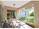 Enclosed lanai featuring tile flooring and outdoor seating with a view of the backyard at 4845 Post Pointe Dr, Sarasota, FL 34233