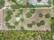 Aerial view of property featuring buildings, mature trees, and potential for various uses at 5034 257Th E St, Myakka City, FL 34251