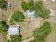 Expansive aerial view of the property showcasing its buildings, mature trees and surrounding landscape at 5034 257Th E St, Myakka City, FL 34251
