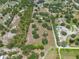 Aerial view of sprawling acreage with mature trees and buildings at 5034 257Th E St, Myakka City, FL 34251