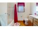 Cozy bathroom featuring a tiled shower, wooden accents, and a bright window for natural light at 5034 257Th E St, Myakka City, FL 34251