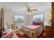 Bedroom with hardwood floors, natural light from the windows, and a charming ceiling fan at 5034 257Th E St, Myakka City, FL 34251