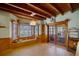 Cozy dining area featuring wood paneling, a window seat, and charming accents at 5034 257Th E St, Myakka City, FL 34251