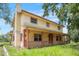 Spacious two-story home featuring a classic covered front porch, offering charming curb appeal at 5034 257Th E St, Myakka City, FL 34251