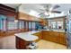 Cozy kitchen featuring wood cabinetry, a breakfast bar, and bright natural lighting at 5034 257Th E St, Myakka City, FL 34251