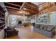 Open-concept living room boasts exposed beams, fireplace, and a cozy seating area with natural light at 5034 257Th E St, Myakka City, FL 34251