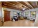 Living room featuring exposed wood beams, lots of windows, and hardwood floors at 5034 257Th E St, Myakka City, FL 34251