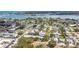 Overhead view of a charming residential area near a bay, highlighting the community's layout and lush surroundings at 516 Parkdale Mews # 516, Venice, FL 34285