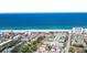 Stunning aerial view of a beachfront neighborhood with pristine sandy beach and turquoise ocean waters at 516 Parkdale Mews # 516, Venice, FL 34285