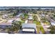 Aerial view of condo building featuring covered parking and well maintained landscaping near a scenic lake at 516 Parkdale Mews # 516, Venice, FL 34285