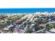 Breathtaking aerial view of a vibrant coastal community, nestled amidst lush greenery and the stunning ocean at 516 Parkdale Mews # 516, Venice, FL 34285