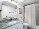Bathroom featuring granite countertop, shower with curtain, and wood floor at 516 Parkdale Mews # 516, Venice, FL 34285
