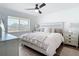 Bright bedroom with bed, ceiling fan, and light wood floor at 516 Parkdale Mews # 516, Venice, FL 34285
