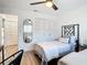 Bright bedroom featuring two twin beds, ceiling fan, and closet with wood floor at 516 Parkdale Mews # 516, Venice, FL 34285