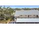 Exterior view of condo building featuring covered parking, and a well maintained landscaped yard at 516 Parkdale Mews # 516, Venice, FL 34285