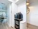 Hallway view featuring modern bar cart with microwave and wall decorations for a contemporary aesthetic at 516 Parkdale Mews # 516, Venice, FL 34285