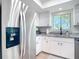 Updated kitchen featuring stainless steel fridge, granite countertops, and ample cabinet space at 516 Parkdale Mews # 516, Venice, FL 34285