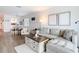 Bright living room featuring a sectional sofa, a view to the dining room, and modern furnishings at 516 Parkdale Mews # 516, Venice, FL 34285