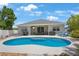 Gorgeous backyard with a large pool, patio seating, and lush tropical landscaping offering privacy at 5419 Lakehurst Ct, Palmetto, FL 34221