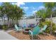 This backyard features a fire pit, a swing, and Adirondack chairs, offering a cozy outdoor retreat at 5419 Lakehurst Ct, Palmetto, FL 34221