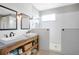 Modern bathroom featuring double sinks, a spacious walk-in shower with white subway tile, and ample natural light at 5419 Lakehurst Ct, Palmetto, FL 34221