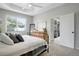 Tranquil bedroom with a tray ceiling, soft natural light, and a dresser. Ensuite is visible through the doorway at 5419 Lakehurst Ct, Palmetto, FL 34221