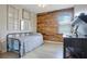 Bedroom with unique wood accent wall, computer desk, and metal framed bed with bright window at 5419 Lakehurst Ct, Palmetto, FL 34221
