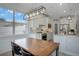 Contemporary eat-in kitchen featuring white cabinets, stainless steel appliances, and a cozy dining area at 5419 Lakehurst Ct, Palmetto, FL 34221