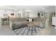Bright living room showcases an open-concept design with a comfortable sectional couch and updated kitchen at 5419 Lakehurst Ct, Palmetto, FL 34221