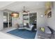 A covered patio features comfortable seating, a ceiling fan, and a view of the kitchen through sliding glass doors at 5419 Lakehurst Ct, Palmetto, FL 34221