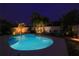 Inviting backyard pool area with lush landscaping, ambient lighting, and comfortable seating for outdoor relaxation at 5419 Lakehurst Ct, Palmetto, FL 34221