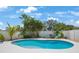 Backyard oasis with refreshing pool surrounded by lush palm trees and comfortable seating at 5419 Lakehurst Ct, Palmetto, FL 34221