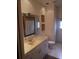 Well-lit bathroom featuring a vanity with framed mirror, toilet, and a tiled floor at 5449 Downham Mdws, Sarasota, FL 34235