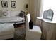 Bright bedroom featuring a daybed, vanity table, and zebra-print rug at 5449 Downham Mdws, Sarasota, FL 34235
