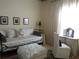 Cozy bedroom featuring a daybed with decorative pillows, a vanity, and natural light at 5449 Downham Mdws, Sarasota, FL 34235