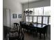 Dining area with a dark wood table, patterned chairs, and a modern chandelier at 5449 Downham Mdws, Sarasota, FL 34235