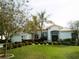 Charming single-story home with manicured lawn, lush landscaping, and attached garage at 5449 Downham Mdws, Sarasota, FL 34235