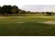 Golf course view featuring lush grass, sand trap, and a scenic landscape at 5449 Downham Mdws, Sarasota, FL 34235
